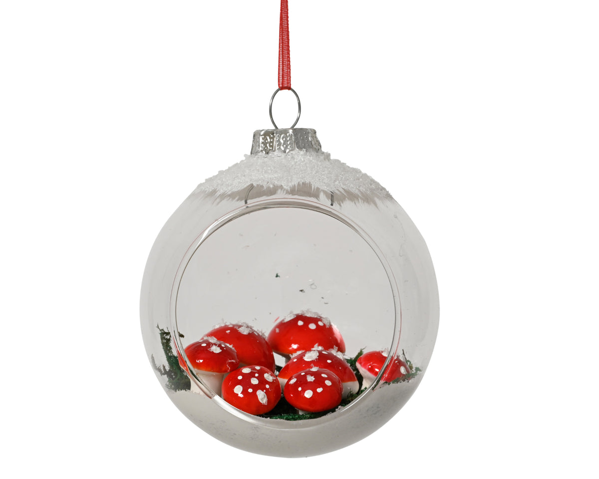 Mushrooms in snow in glass bauble