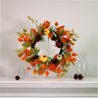 Autumn leaves, pumpkins and pine cone wreath