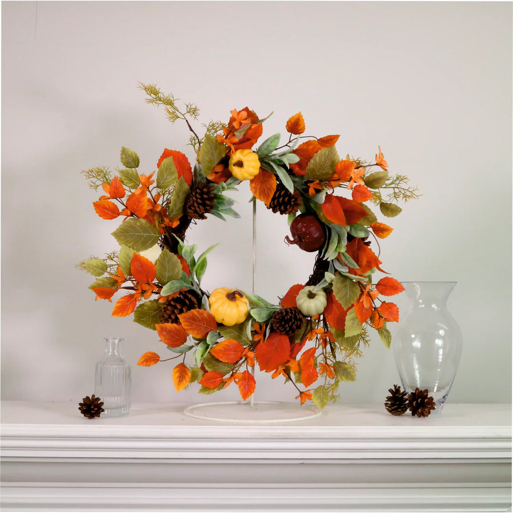 Autumn leaves, pumpkins and pine cone wreath