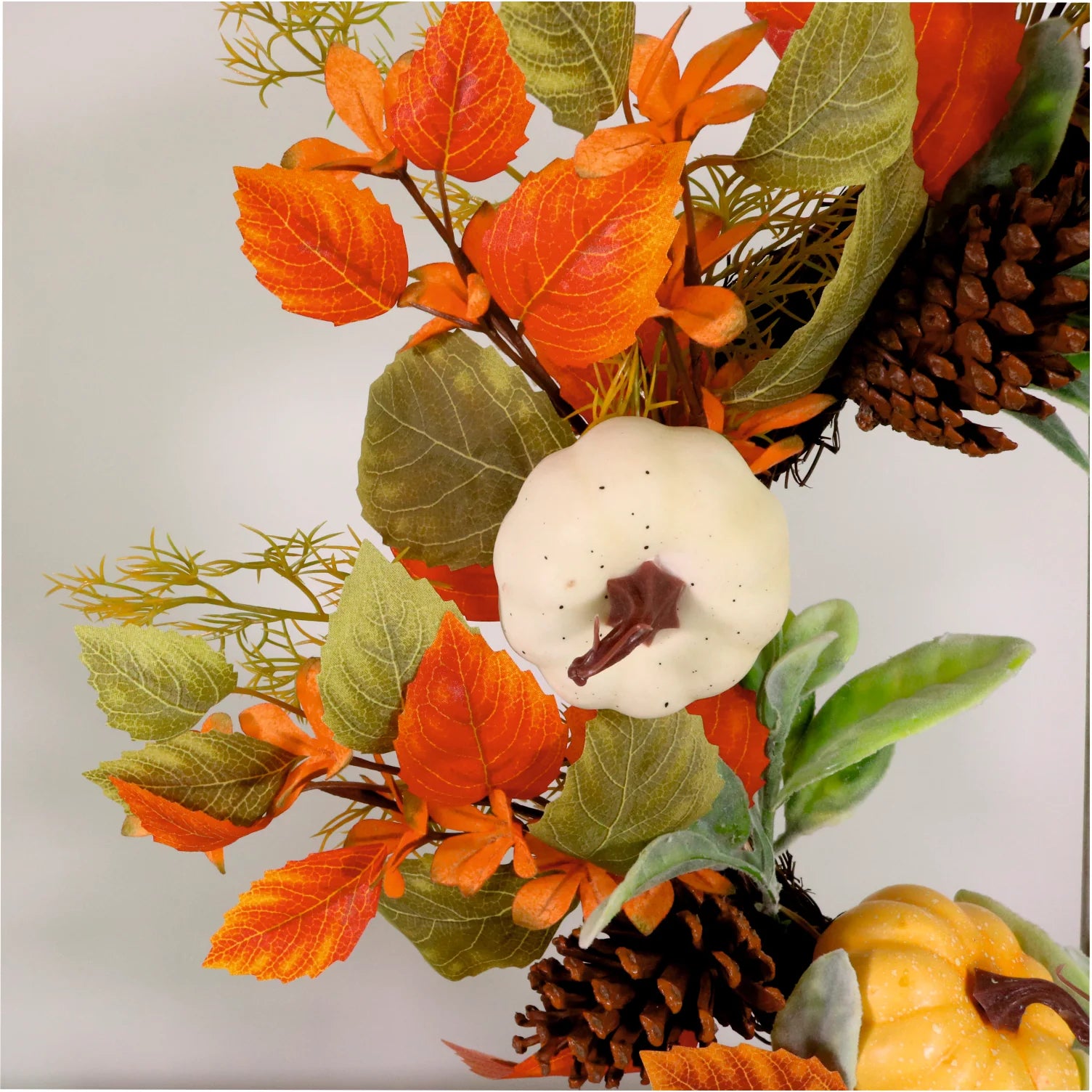 Autumn leaves, pumpkins and pine cone wreath