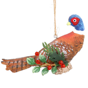 Festive pheasant on holly log