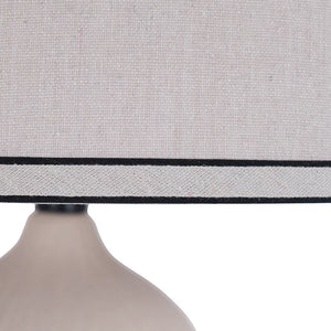 Ivory ceramic lamp with oatmeal and black trim shade