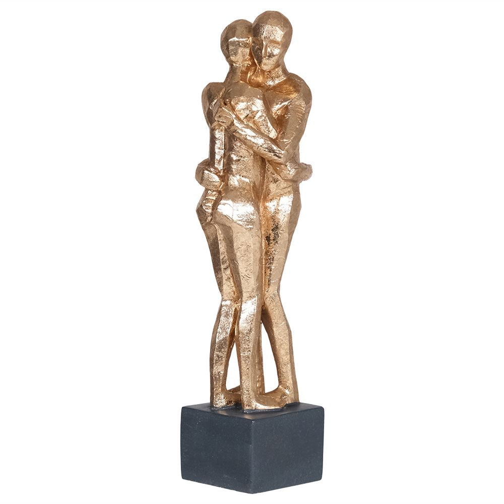 Golden sculpture of couple hugging