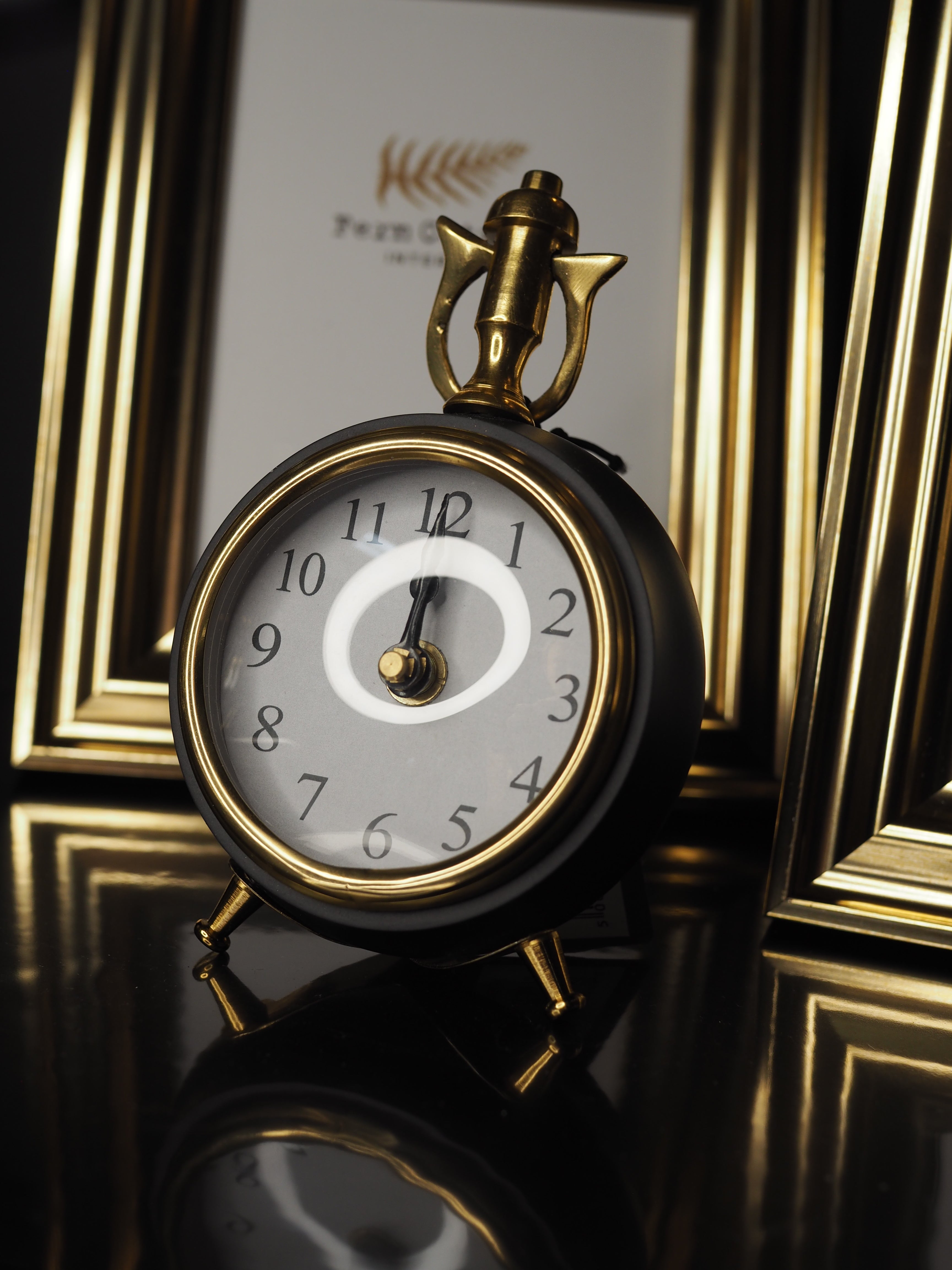 Black and brass round table clock
