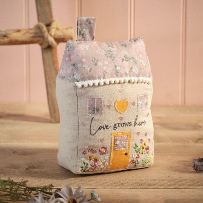 Ditsy floral 'Love Grows Here' fabric house shaped doorstop