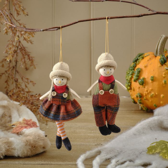 Harvest pumpkin dressed girl and boy hanging dec