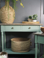 Two drawer green console table with shelf