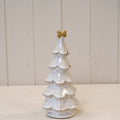 Medium stone glazed Christmas tree topped with a cream bow