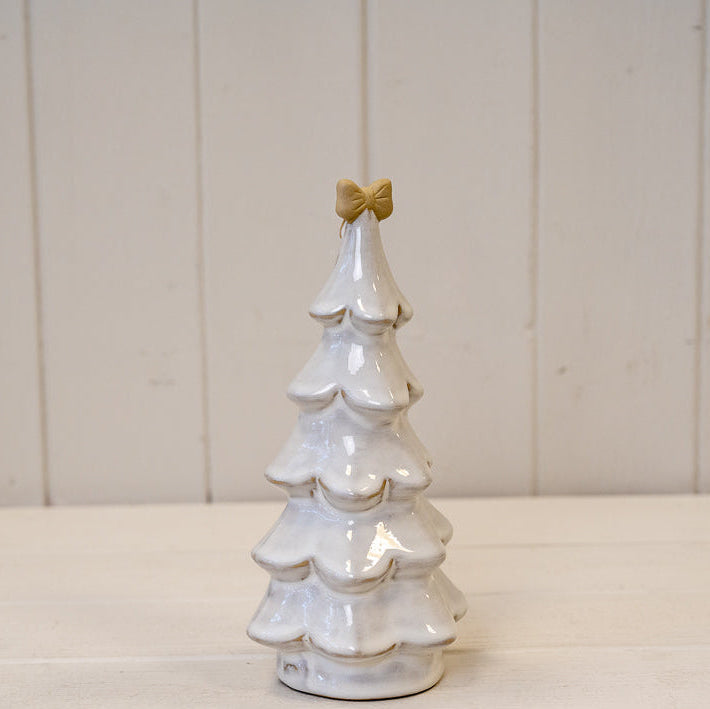 Medium stone glazed Christmas tree topped with a cream bow