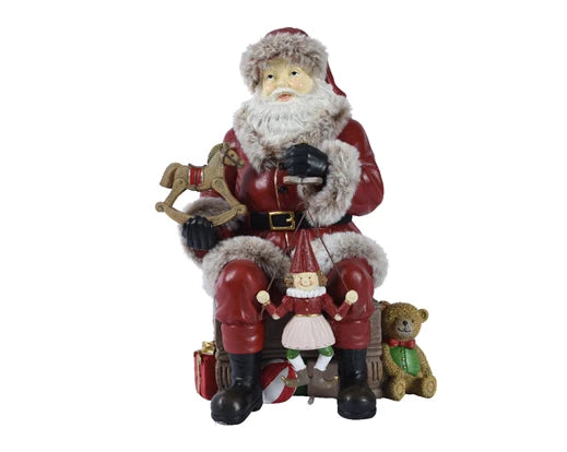 Vintage sitting Santa ornament with nutcracker and toys