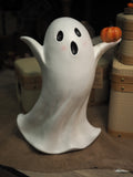 Tall ghost holding pumpkin
