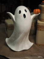 Tall ghost holding pumpkin