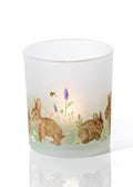Two candle holders with rabbit designs on a white background