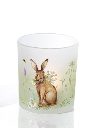 Two candle holders with rabbit designs on a white background