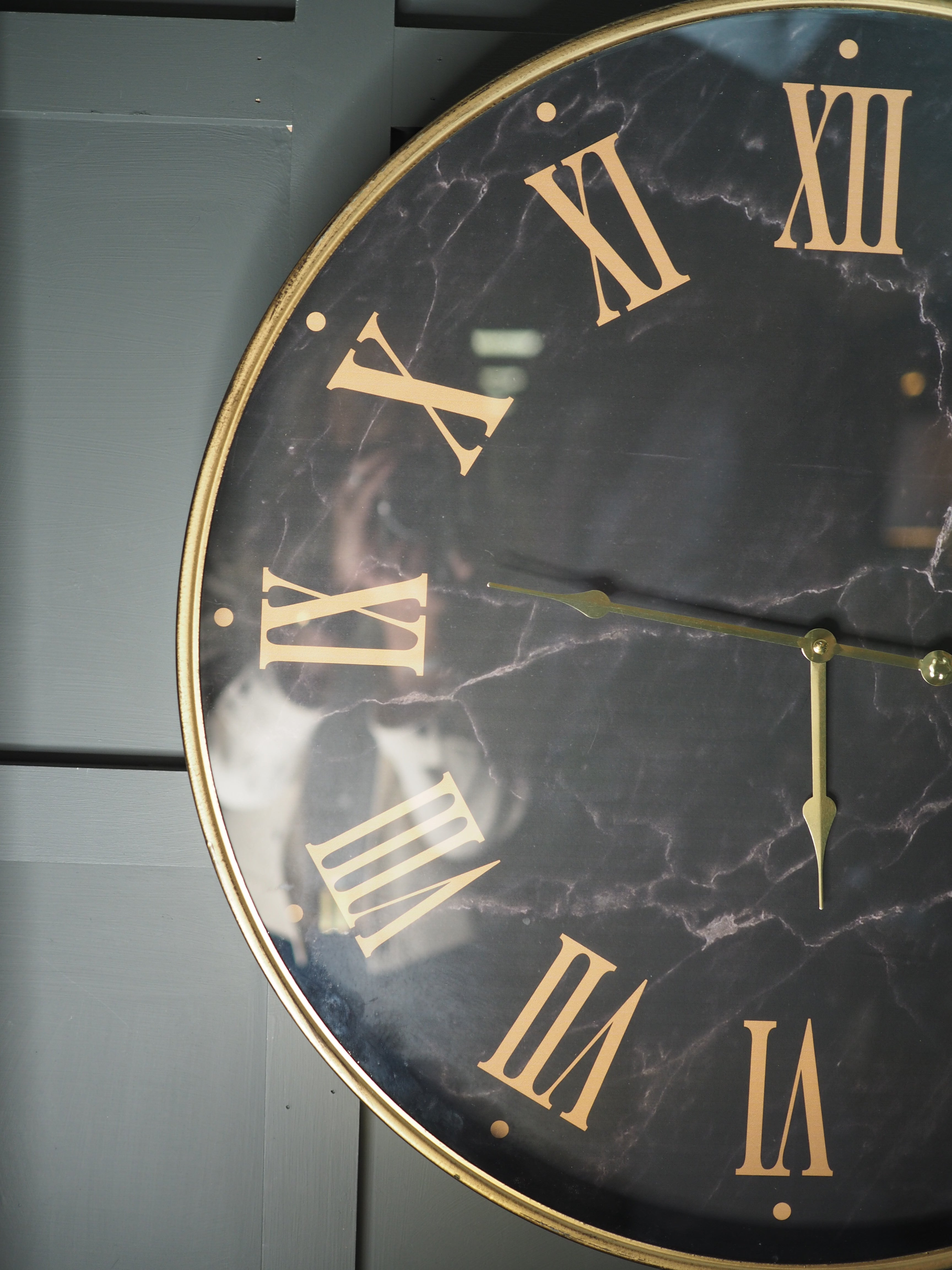 Black marble face clock with gold Roman numerals