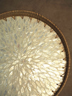Round rattan tray with capiz detail