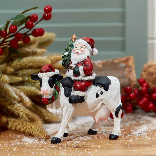 Santa on a cow ornament