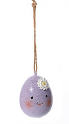 Three decorative eggs with faces on a white background