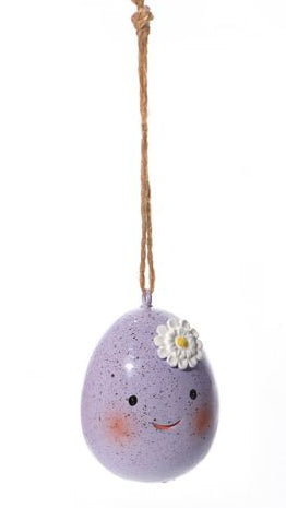 Three decorative eggs with faces on a white background