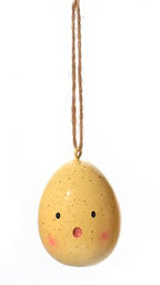 Three decorative eggs with faces on a white background