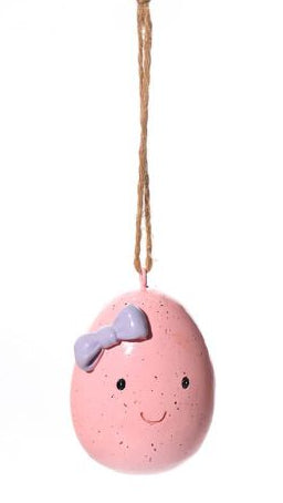 Three decorative eggs with faces on a white background