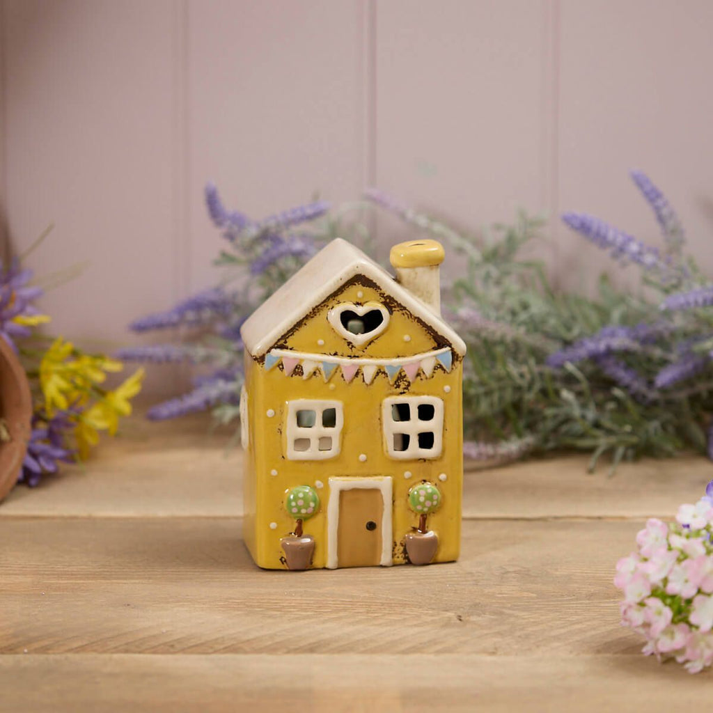 Yellow house with bunting tea light holder
