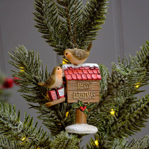 Festive robins perched on a postbox dec