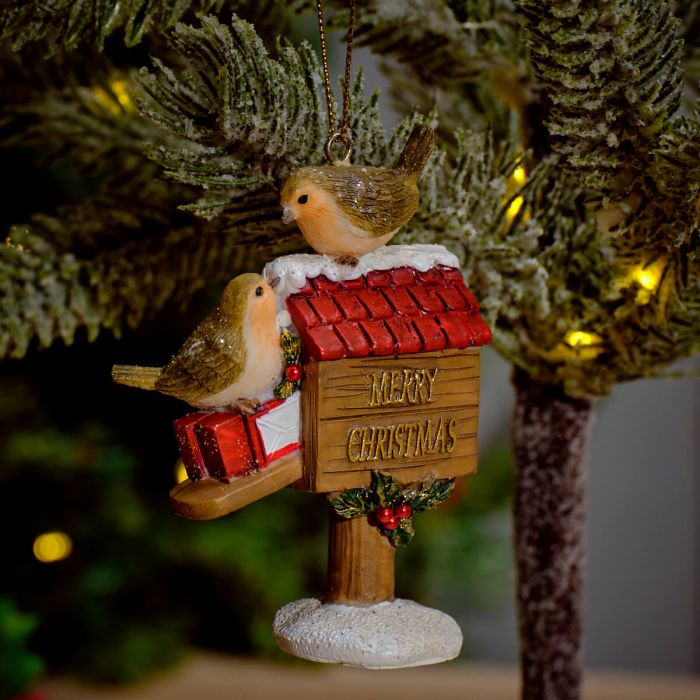 Festive robins perched on a postbox dec