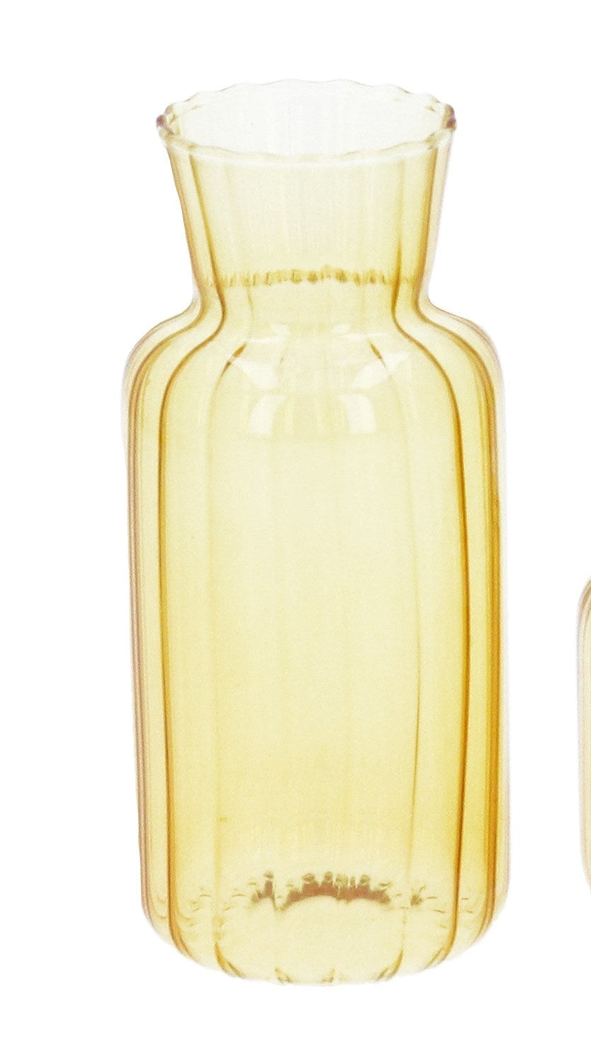 Two yellow glass vases on a white background