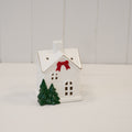 Medium Christmas house with red bow and trees - H 12cm
