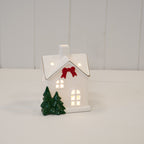 Medium Christmas house with red bow and trees - H 12cm