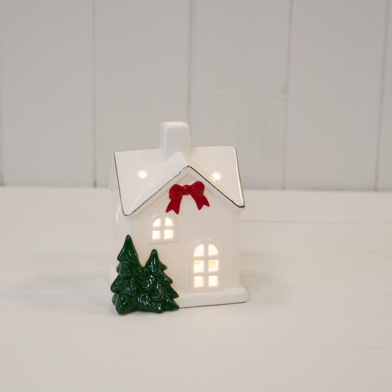 Medium Christmas house with red bow and trees - H 12cm