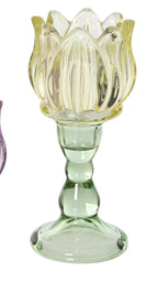 Three colorful glass candle holders shaped like lotus flowers on a white background