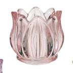 Three glass candle holders in pink, purple, and yellow on a white background