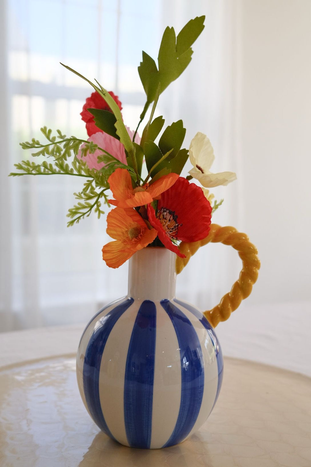 Blue & white stripe vase with yellow rope handle