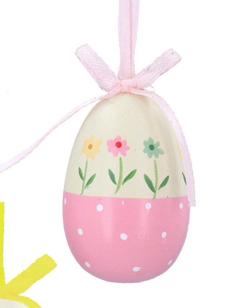 Three colorful Easter egg ornaments with floral designs and ribbons on a white background