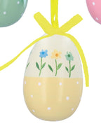 Three colorful Easter egg ornaments with floral designs and ribbons on a white background