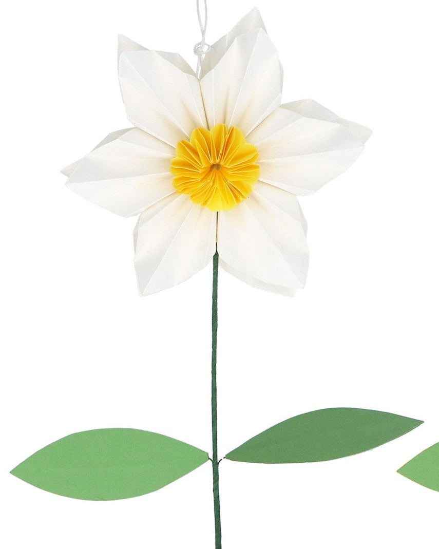 Two decorative flowers, one white with a yellow center and the other yellow with a white center, on a white background. There is also a cardboard packaging box with a flower design.