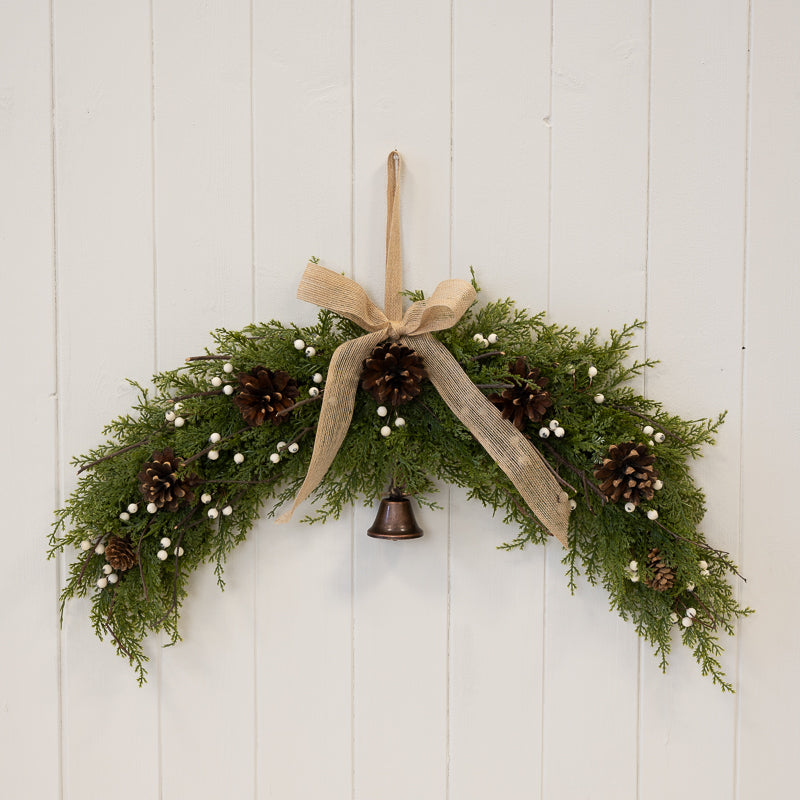 White berry & pinecone swag with bell and bow
