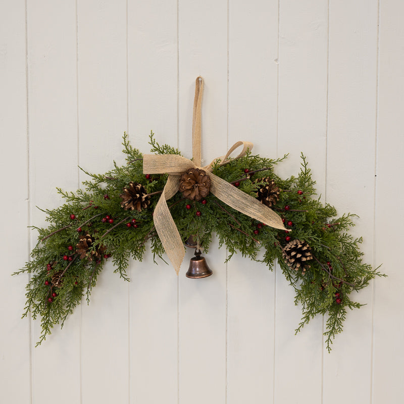 Red berry & pinecone swag with bell and bow
