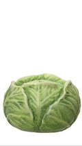 Three ceramic vegetable sculptures on a white background