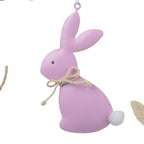 Set of colorful Easter-themed decorations including bunnies, eggs, and flowers on a white background.