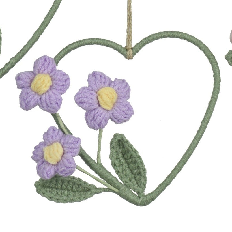 Set of four heart-shaped floral decorations with colorful flowers on a white background