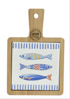 Two wooden cutting boards with fish patterns on a white background