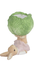 Two figurines with cabbage hats on a white background