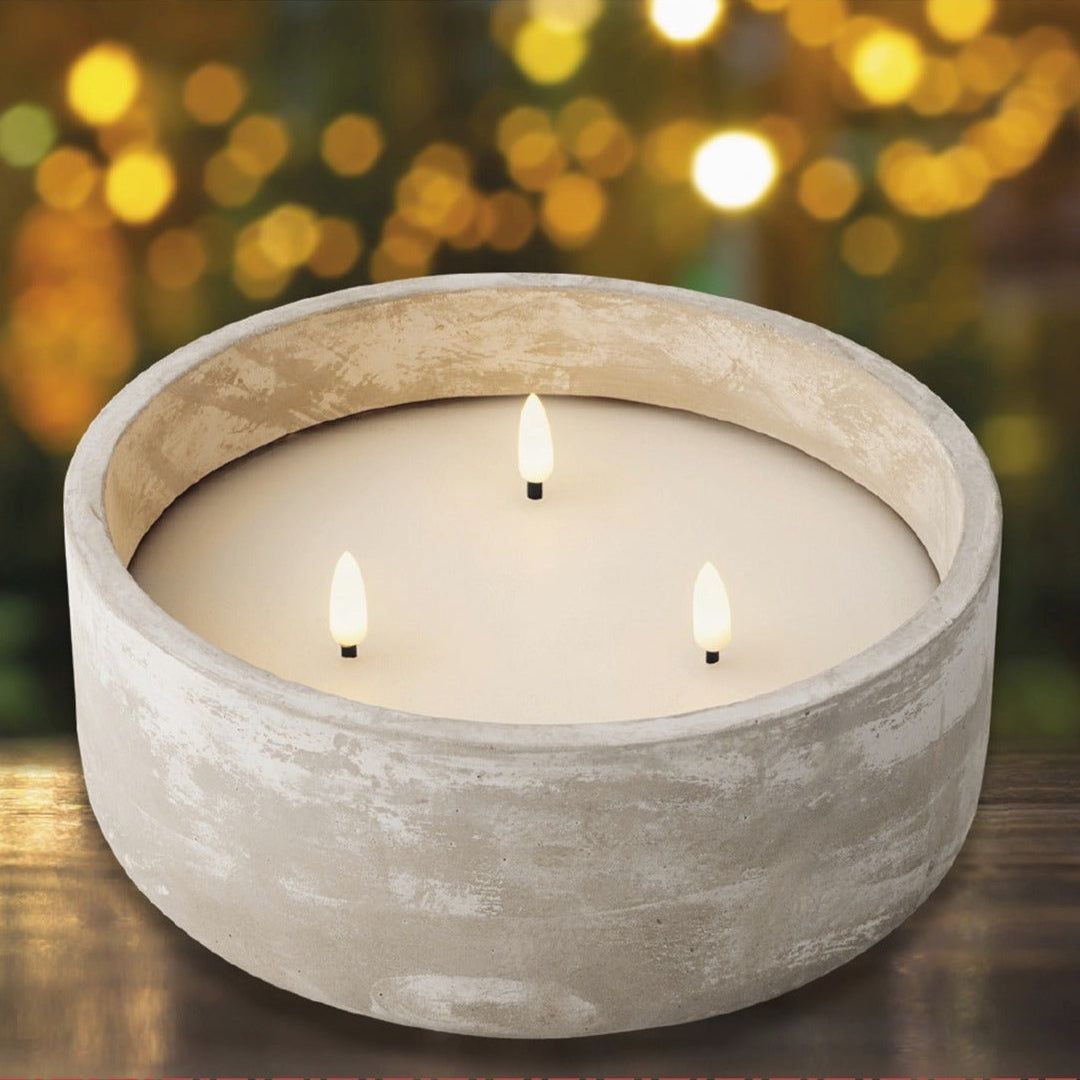 Lumineo wax candle with LED light on a wooden surface, blurred lights in the background