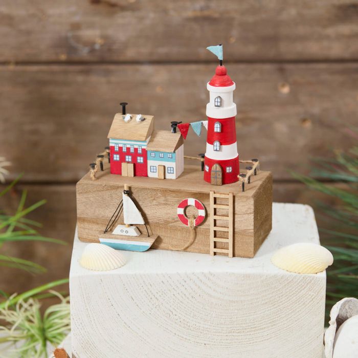 Nautical wooden harbour with lighthouse and boat