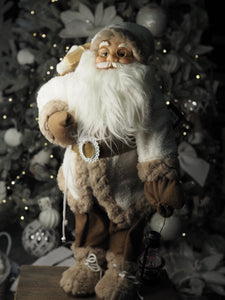 Santa with fur coat carrying his sack and bronze lantern