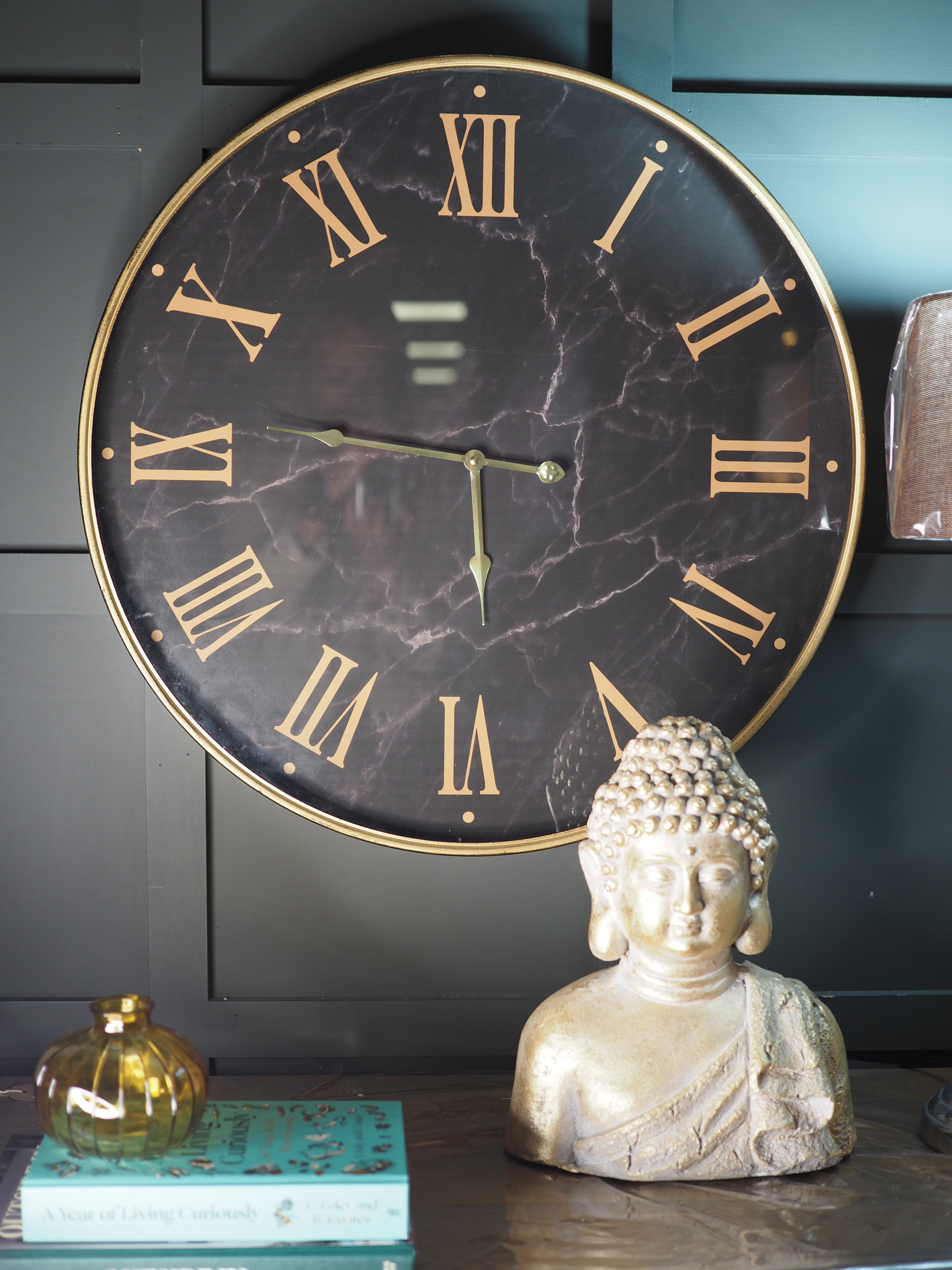 Black marble face clock with gold Roman numerals