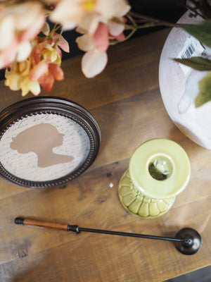 Black candle snuffer with wooden handles